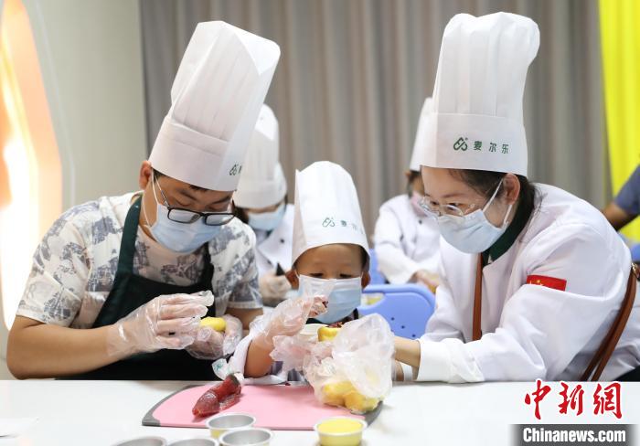 家长带着孩子在宁夏万杞园枸杞食品文化馆体验月饼DIY。 于晶 摄 家长带着孩子在宁夏万杞园枸杞食品文化馆体验月饼DIY。 于晶 摄